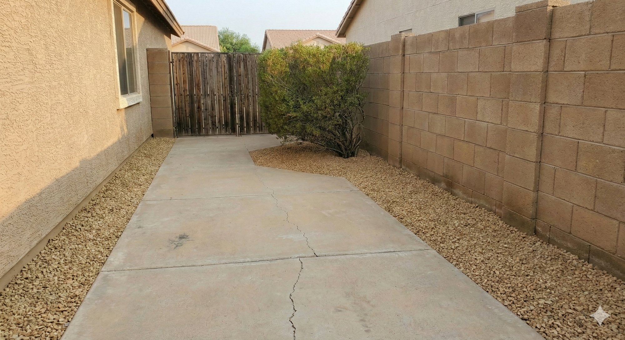 Side yard after: clean path, fresh gravel, trimmed